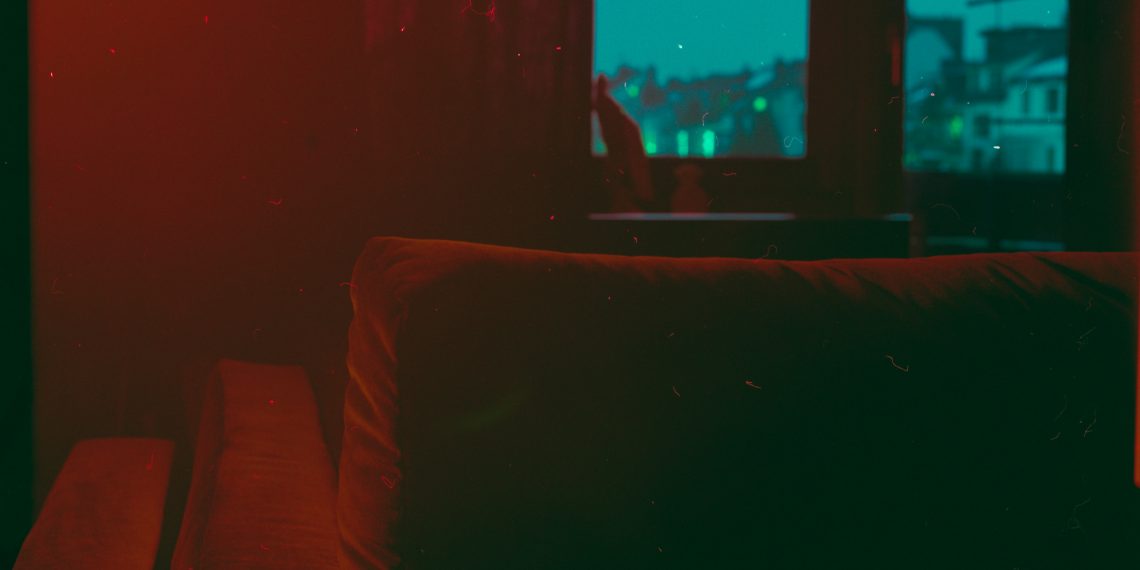 red sofa chair near window